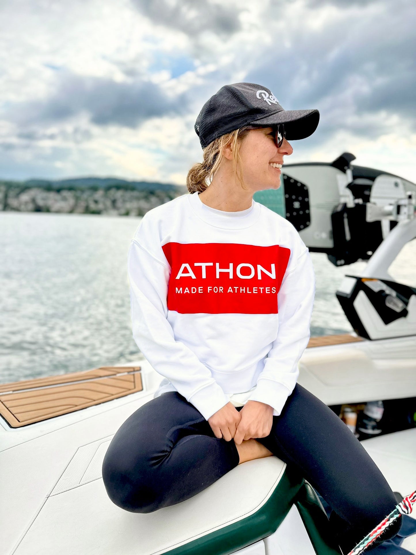 Athon logo women's sweater worn by model on a lake